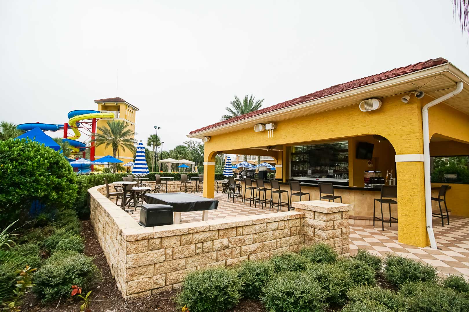 A quaint outdoor bar lounging area at VRI's Fantasy World Resort in Florida.